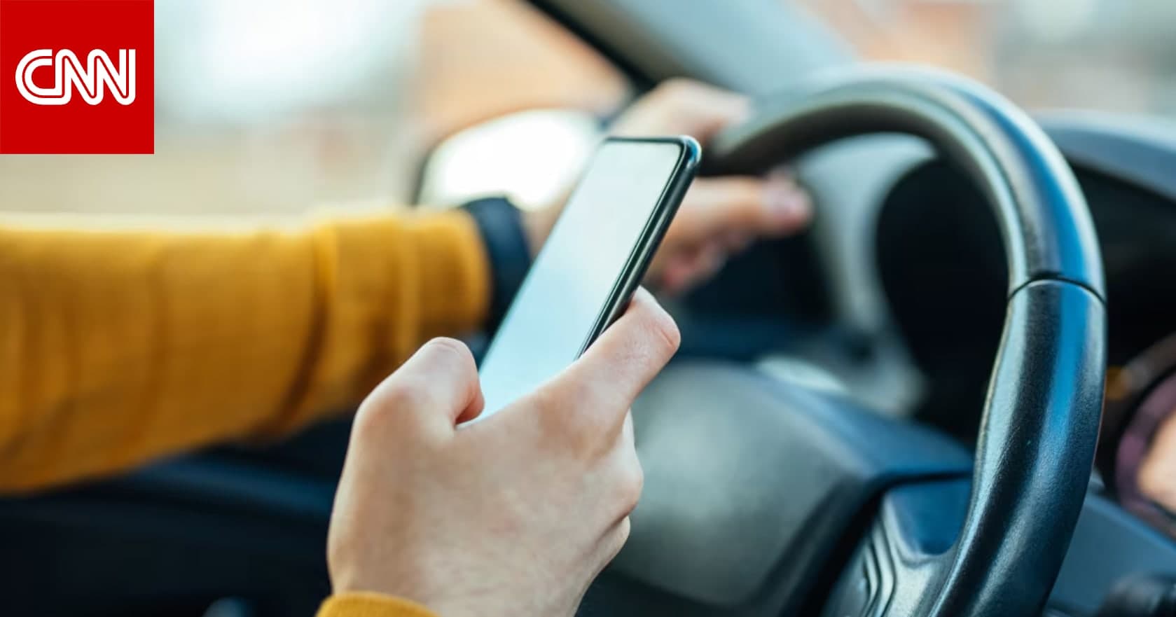 Driver using smartphone while driving causing distraction